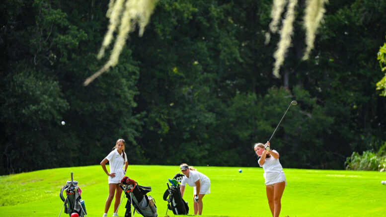 Teenage girls golfing