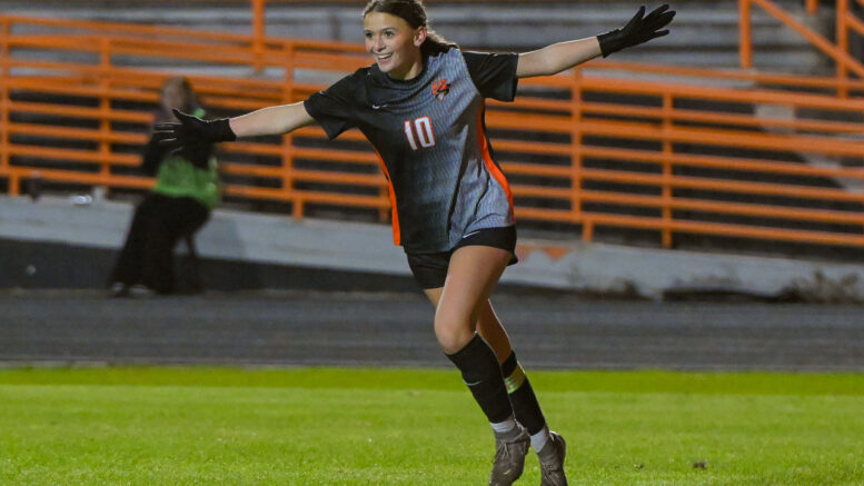 Girl celebrating scoring in soccer game