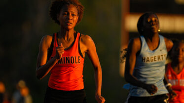 High School girl running in race.