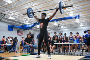 High School Boys lifting weights at meet