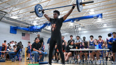 High School Boys lifting weights at meet